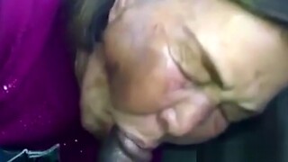 Elder Asian woman gives oral pleasure to black man during massage